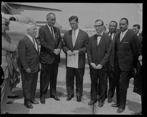 Vice President Lyndon Johnson standing with Governor Endicott Peabody and other men at the airport