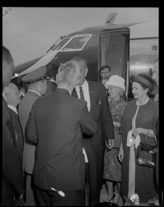 Vice President Lyndon Johnson shaking hands with a man after exiting an airplane