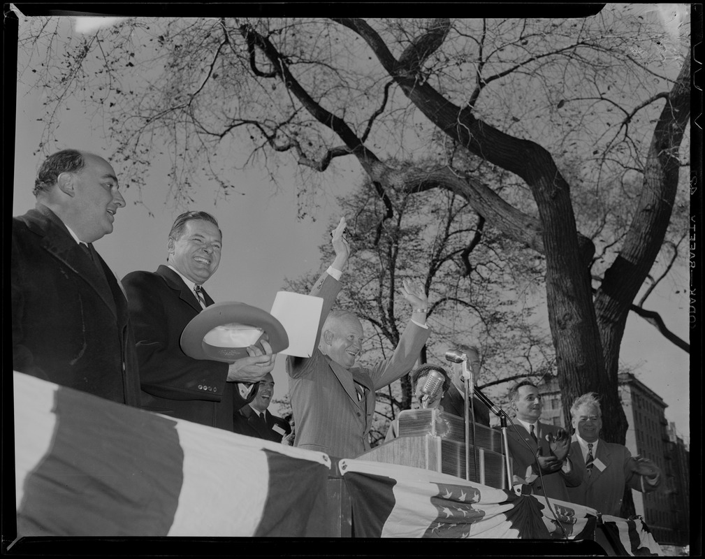 General Eisenhower waves to the crowd from a stage