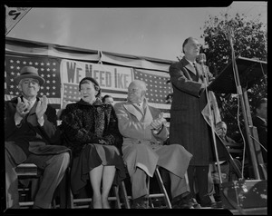 General Eisenhower seated on stage with his wife Mamie at his side and Senator Leverett Saltonstall on the far left