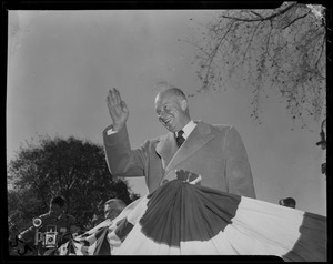 General Eisenhower waves to the crowd from a stage