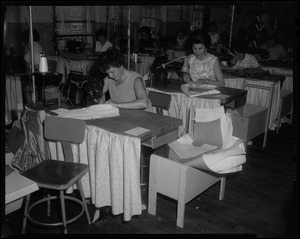 Women at sewing tables working on Luci Johnson's wedding dress