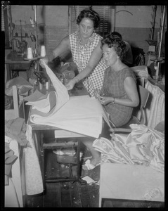 Two women looking at fabric for Luci Johnson's wedding dress