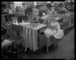 Women at sewing tables working on Luci Johnson's wedding dress
