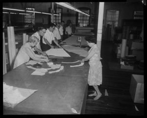 Workers cutting fabric for Luci Johnston's wedding dress