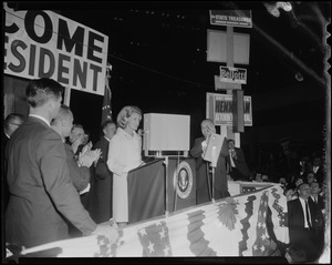 Woman on stage addressing the crowd, possibly Joan Kennedy