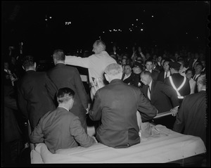 President Johnson waving to the crowd from convertible in the motorcade