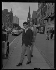Prince Alexandre on the sidewalk on Newbury Street, about to enter a vehicle