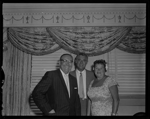 Cary Grant posing for a photo with a man and woman