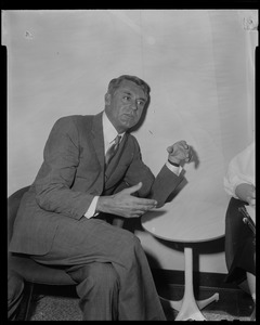 Cary Grant seated and talking animatedly