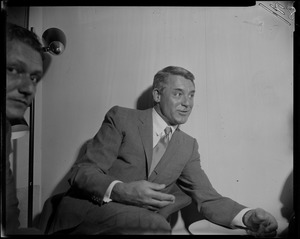 Cary Grant seated and talking animatedly