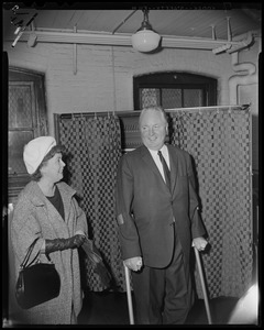 Mayor John F. Collins and his wife Mary in front of voting booth