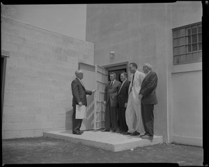 Warden John Gavin standing outside of a doorway with J. David White, George McGrath, Dr. Leon Shapiro, and Francis J. Ryrt
