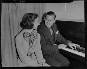 Morton Downey and Ann Marsters sitting beside a piano