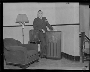 Morton Downey leaning on a radio at Kane's Furniture Store, Washington Street