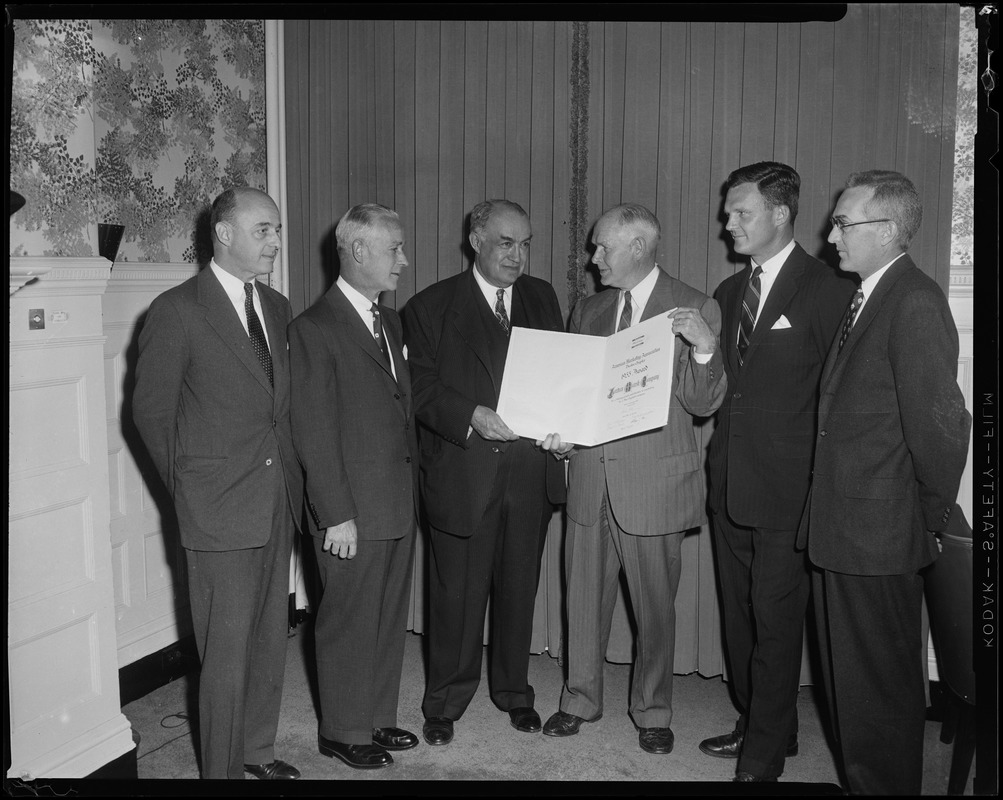 President Edward R. Mitton of Jordan Marsh Company accepting a scroll from the American Marketing Association