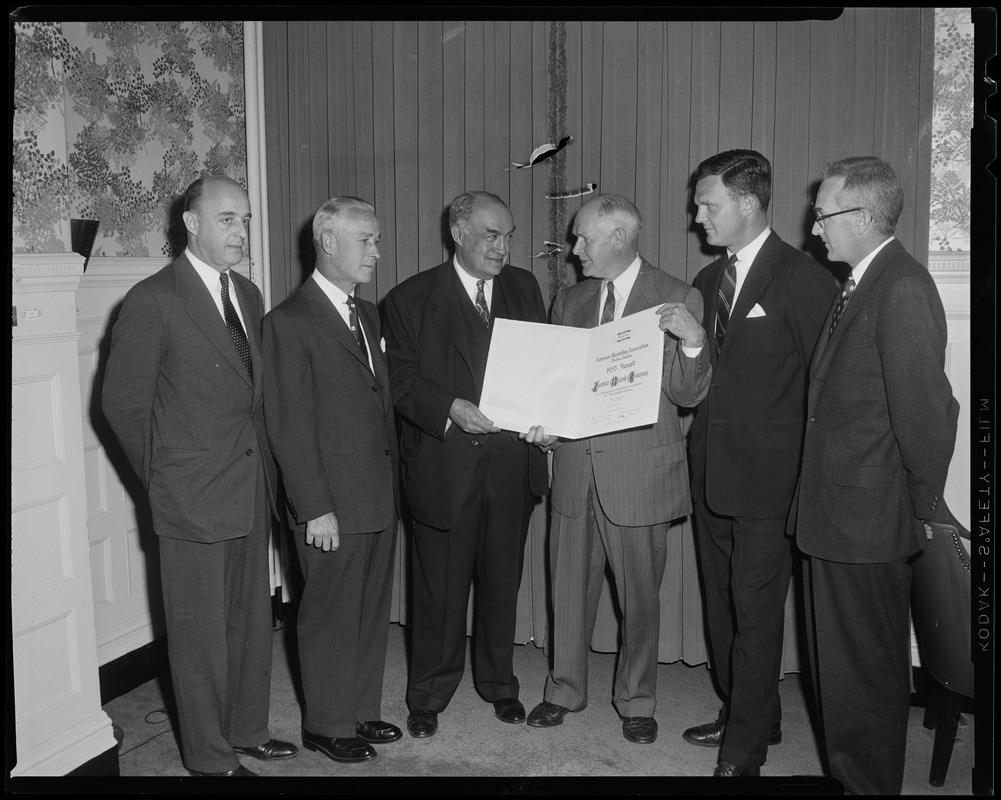 President Edward R. Mitton accepting a scroll by the American Marketing Association