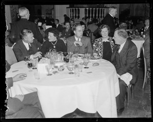 Philip Jefferson, Mrs. Helen Coleman, Henry Wright, Marie Falvey and Edward McElroy sitting at a table at the Jordan Marsh dinner honoring Edward R. Mitton