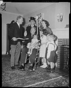 John F. Collins, a polio victim, is sworn in by Mayor John B. Hynes with his family around including wife Mary Patricia