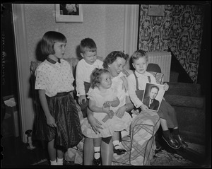 John F. Collins family: wife Mary Patricia and four children, Thomas, Patricia, John, Jr., and Peggy, posing with his photograph