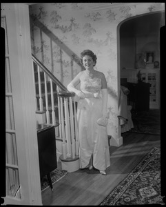 Mrs. John F. Collins in shell pink French silk ball gown for the inauguration, posing at the end of staircase