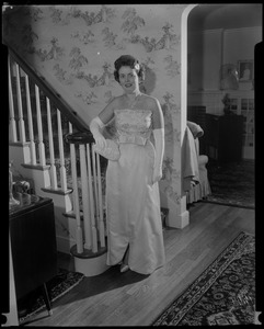 Mrs. John F. Collins in shell pink French silk ball gown for the inauguration, posing at the end of staircase