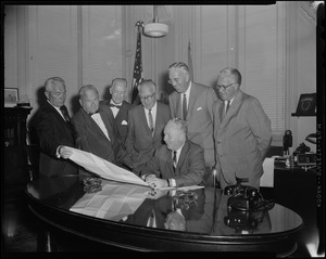 Mayor Collins reviews plans for the new North Terminal with John T. Burke, J. F. Reynolds, Ephraim Brest, Patrick G. Sullivan, and Carl J. Gilbert