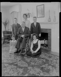 Mayor Collins with family, posing in front of the fireplace