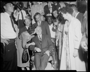 John F. Collins receives a kiss from his wife after the preliminary election