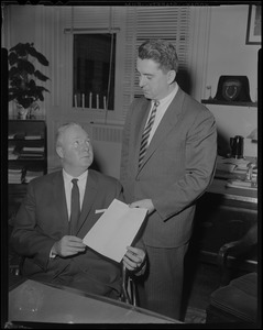 Mayor Collins receiving a document from another man