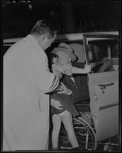 John F. Collins embraces a child