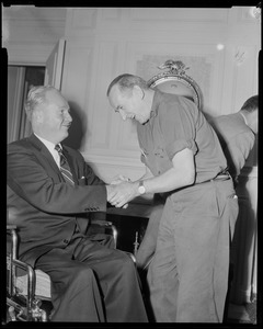 Mayor John F. Collins shaking hands with an older man