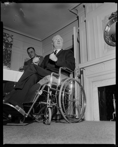 Mayor John F. Collins in front of the fireplace with another man