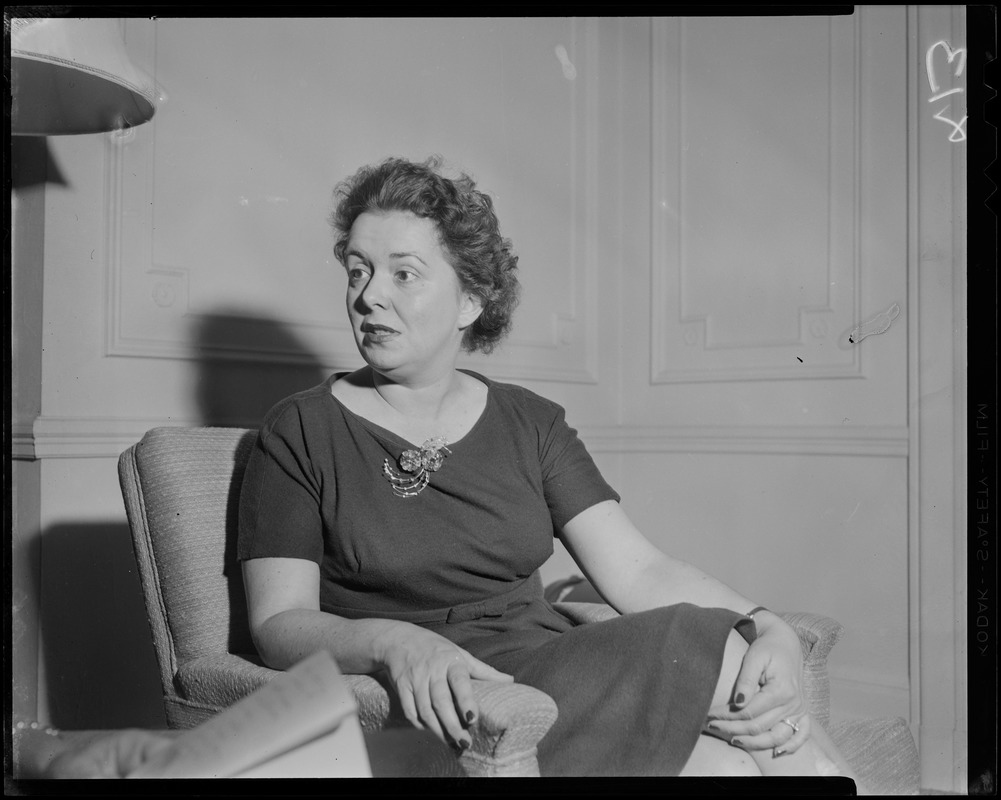 Mary Collins seated, talking with another woman