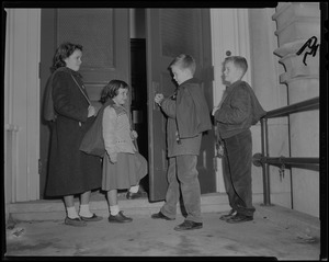 Mayor-elect John F. Collins's children, Patricia, Peggy, Thomas, and John Jr. with bags