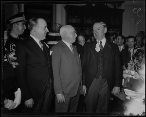 Governor James M. Curley with large pipe and standing with other unidentified men