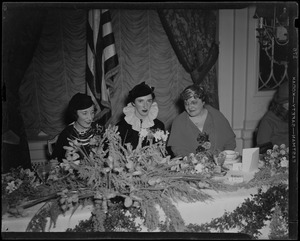 Mary Curley seated between two other women at a head table at the Inaugural Ball
