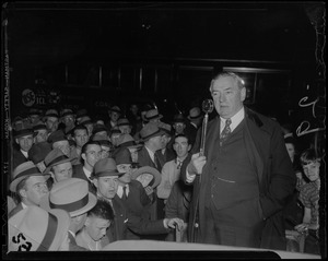 James M. Curley with a microphone in his hand
