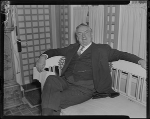 James M. Curley seated on a bench