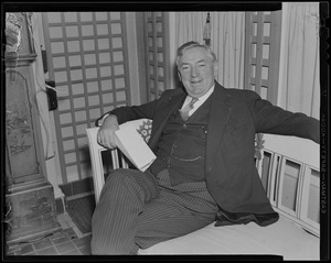 James M. Curley seated on a bench