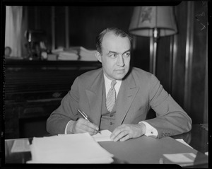 Edward R. Mitton, vice president of the Jordan Marsh Company, sitting at a desk