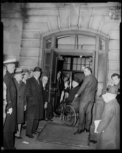 Mayor Collins entering building and waving to the camera
