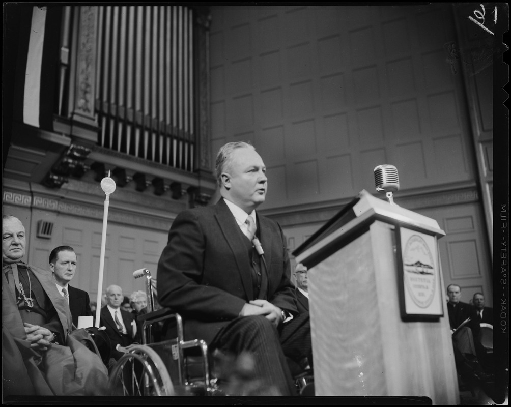 Mayor Collins at the podium, addressing the room