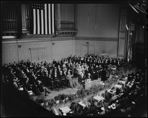 View from the balcony of Mayor Collins at the podium, addressing the room