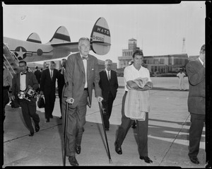 Secretary of State Christian Herter walking away from the airplane after arriving in Boston
