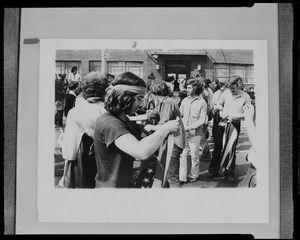 Photograph of students assembling flags for strike in front of the Massachusetts National Guard headquarters