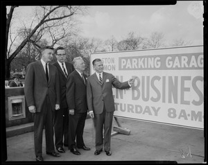 A group of four men, including former Mayor John B. Hynes, standing beside a sign for Boston Common Parking Garage