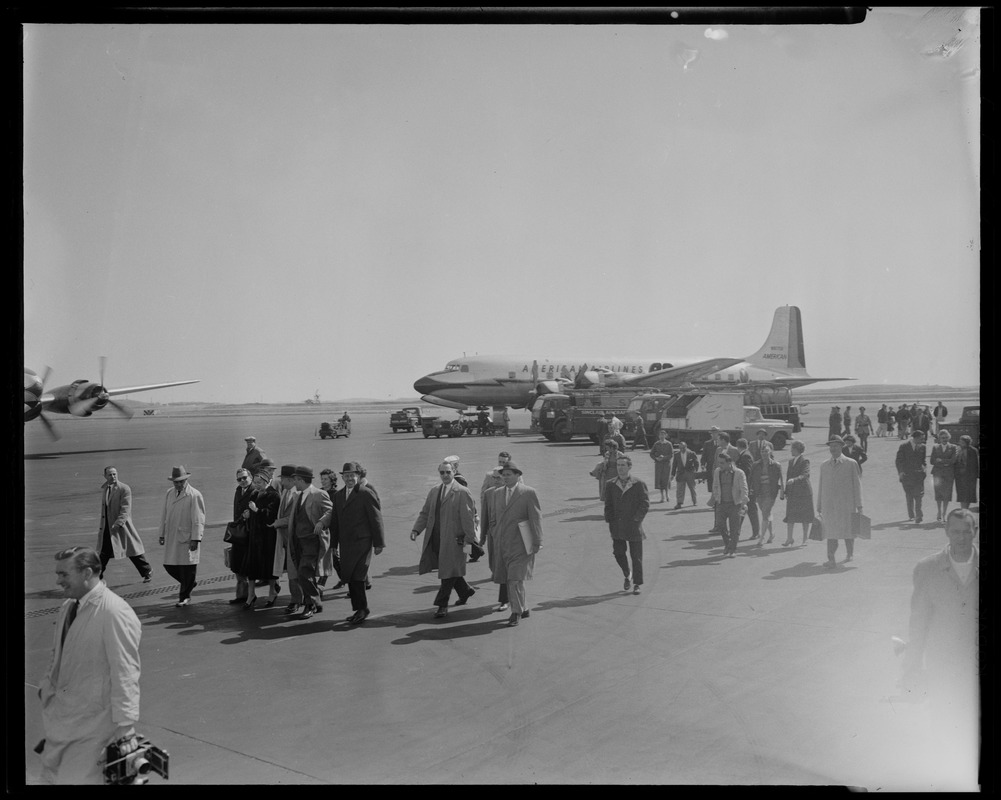 A crowd of people walking on tarmac after the arrival of Lana Turner