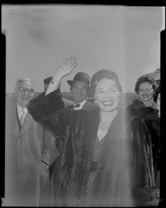 Lana Turner upon arrival at Logan International Airport, waving