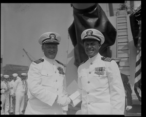 Captain J.F. Enright and Captain G.T. Ferguson, shaking hands at U.S.S. Boston change of command ceremonies at Charlestown Navy Yards